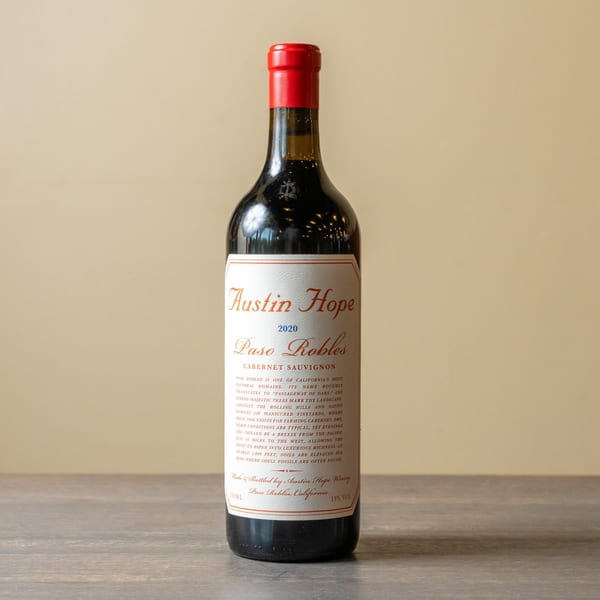 A bottle of Austin Hope Paso Robles Cabernet Sauvignon wine with a red foil top.