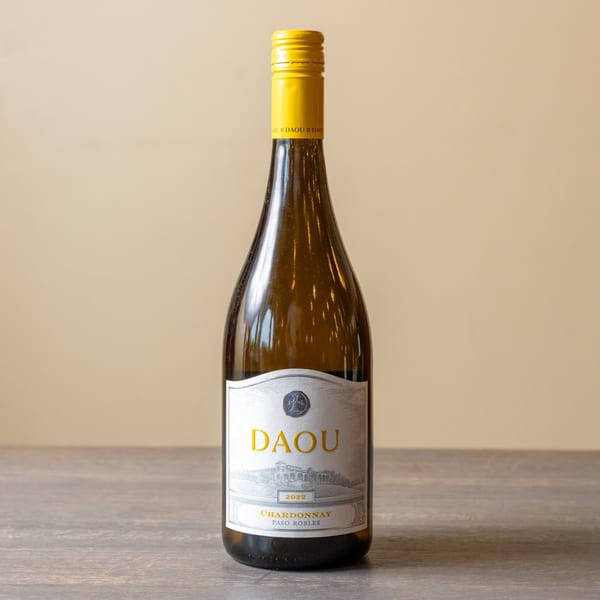 A bottle of Daou 2022 Chardonnay Paso Robles wine with a yellow cap and label.