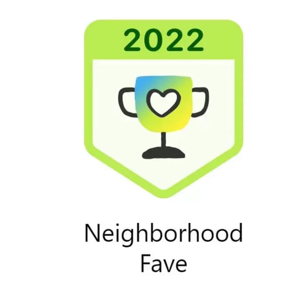 Green and white badge with a trophy icon and text "2022 Neighborhood Fave".